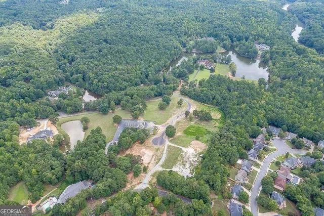 an aerial view of a house with a yard