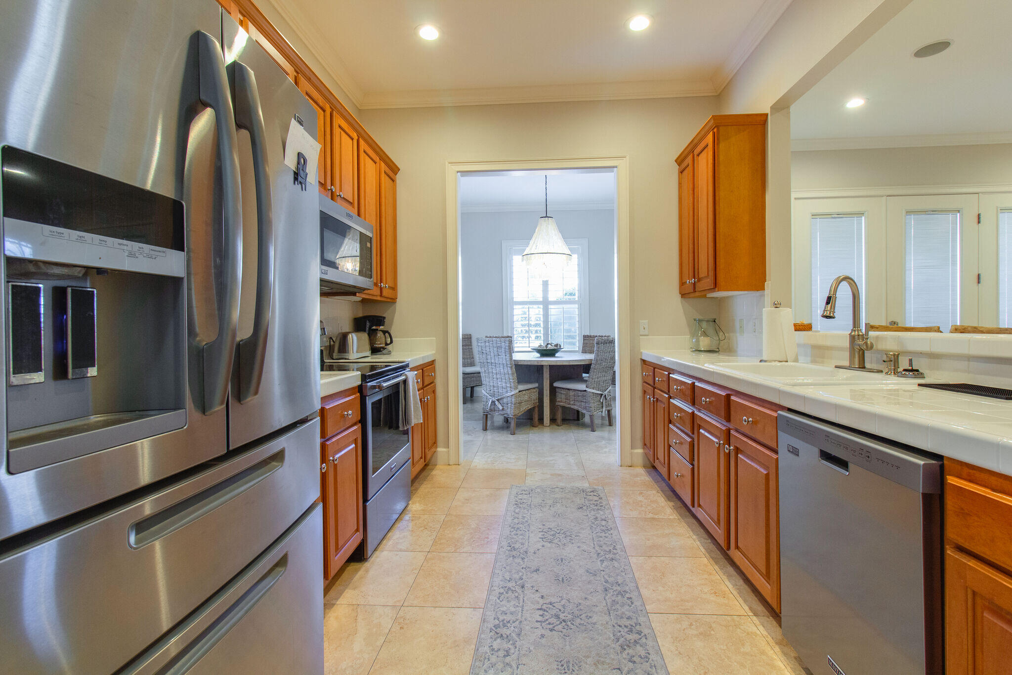 2113 Clipper Cove Miramar Beach, FL 32550 - Photo 9 of 29 a large kitchen with stainless steel appliances a sink and cabinets