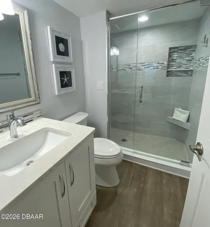 a large bed sitting in a bedroom next to a window