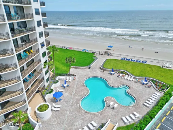 a view of a swimming pool and lounge chairs