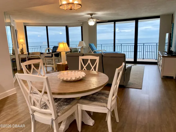 a kitchen with a refrigerator a microwave a sink and white cabinets