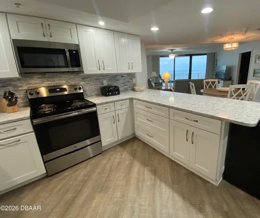 a large bed sitting in a bedroom next to a window