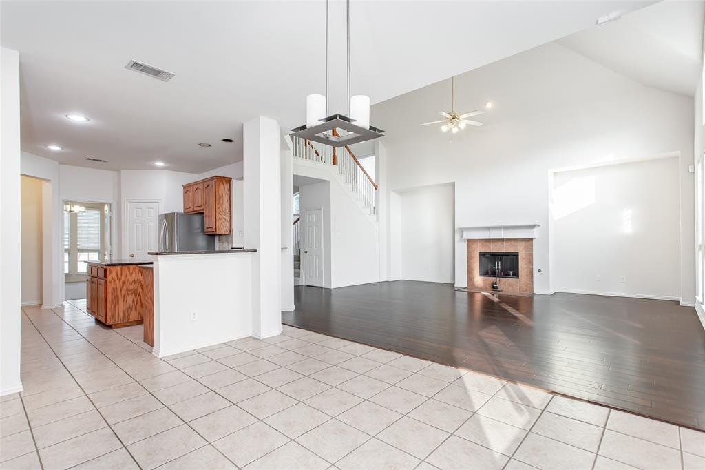 915 Falcon Trail Murphy, TX 75094 - Photo 16 of 40 a view of open kitchen with kitchen island a sink stainless steel appliances and cabinets