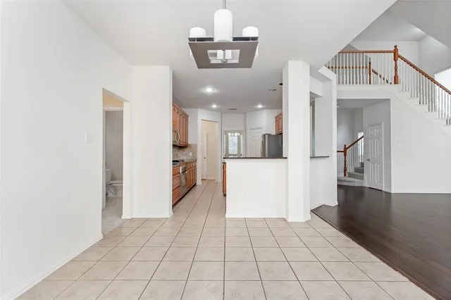 a view of a hallway with a dining table & chairs