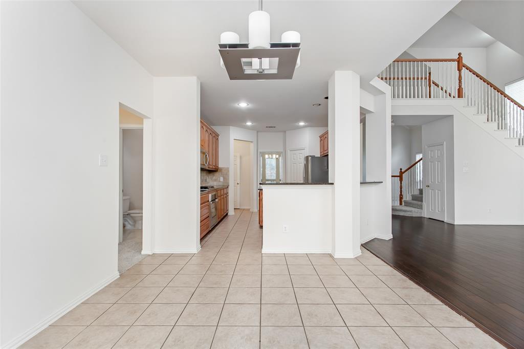 915 Falcon Trail Murphy, TX 75094 - Photo 17 of 40 a view of a hallway with a dining table & chairs