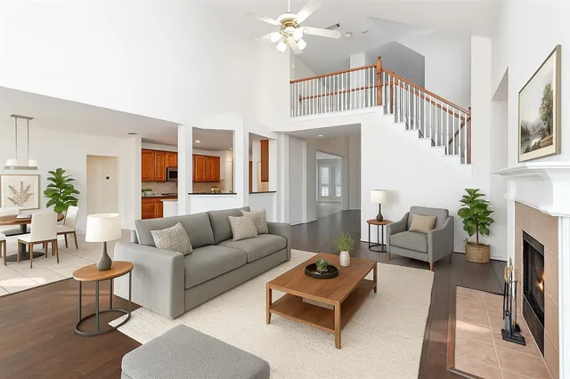 a living room with furniture a fireplace and a chandelier