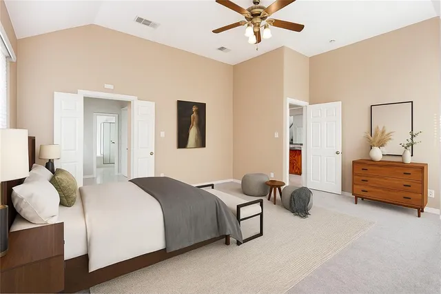 a bedroom with a bed and ceiling fan
