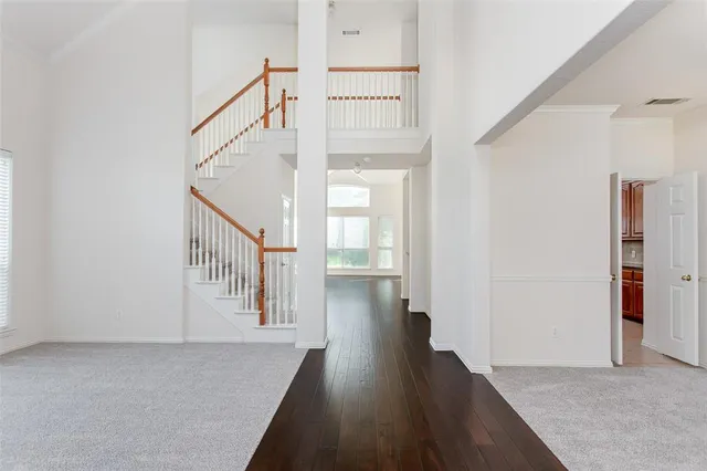 a view of a hallway with wooden floor and entryway