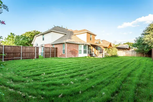a view of a house with a yard and sitting area