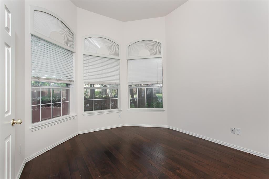 915 Falcon Trail Murphy, TX 75094 - Photo 4 of 40 an empty room with wooden floor and windows