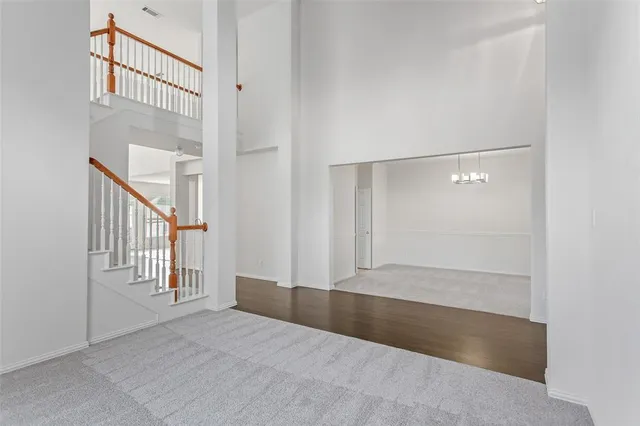 an empty room with windows and stairs