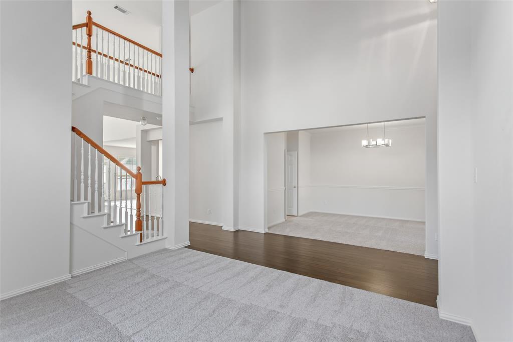 915 Falcon Trail Murphy, TX 75094 - Photo 6 of 40 an empty room with windows and stairs