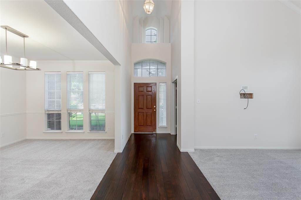 915 Falcon Trail Murphy, TX 75094 - Photo 7 of 40 a view of a hallway with windows and chandelier