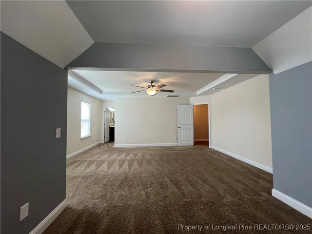 a view of empty room with ceiling fan