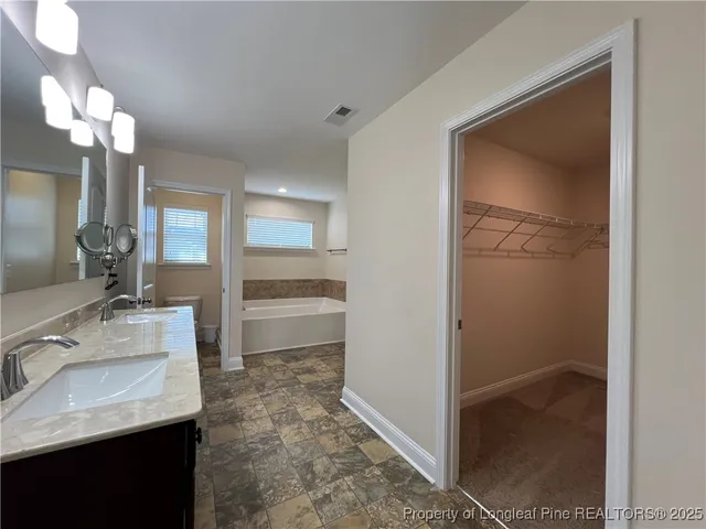 a bathroom with a sink a light fixture and a mirror
