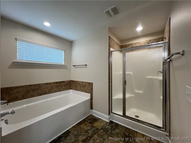a bathroom with a bathtub and a shower