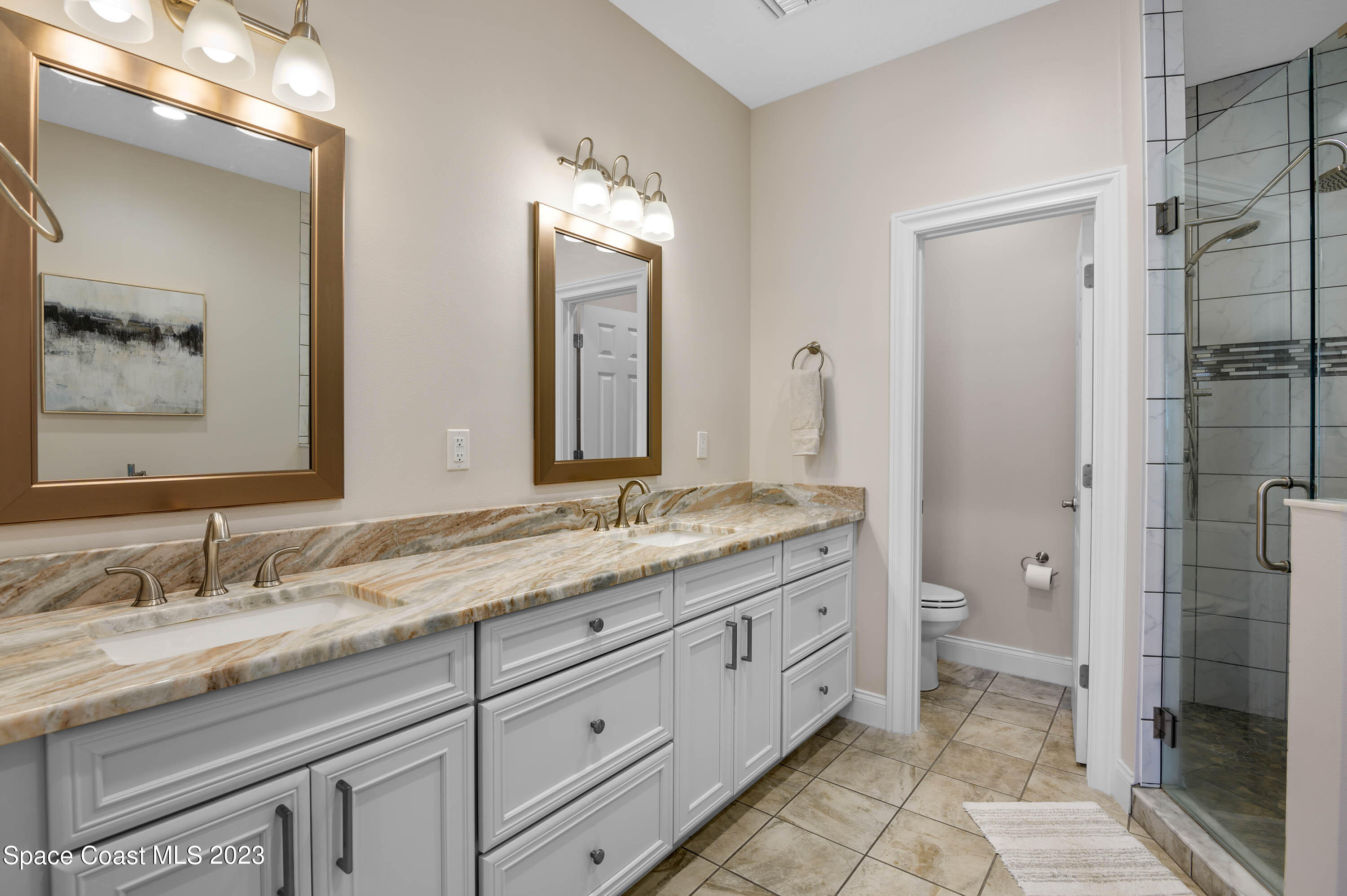 2240 Enjoya Lane Melbourne, FL 32901 - Photo 15 of 31 a bathroom with a granite countertop sink toilet and shower