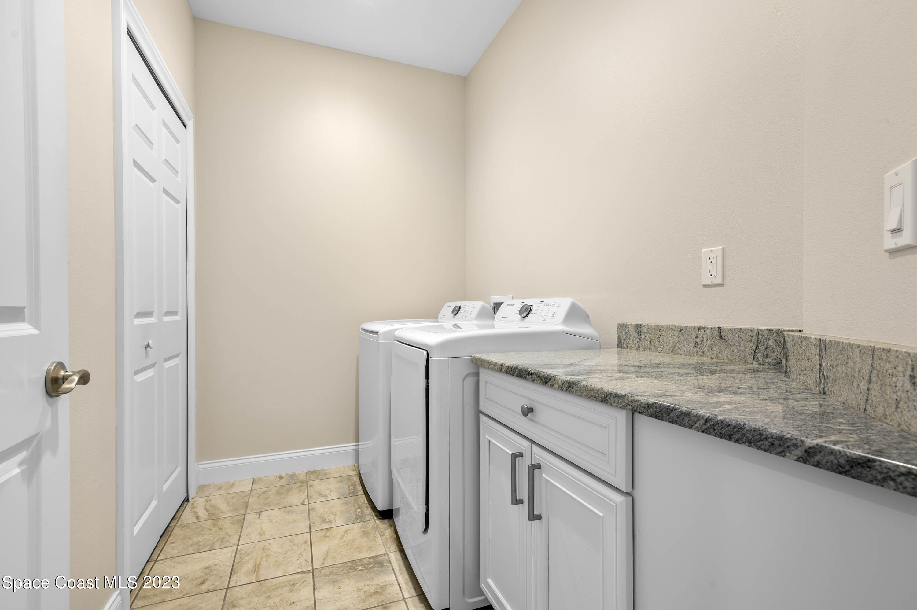 2240 Enjoya Lane Melbourne, FL 32901 - Photo 21 of 31 a utility room with cabinets washer and dryer