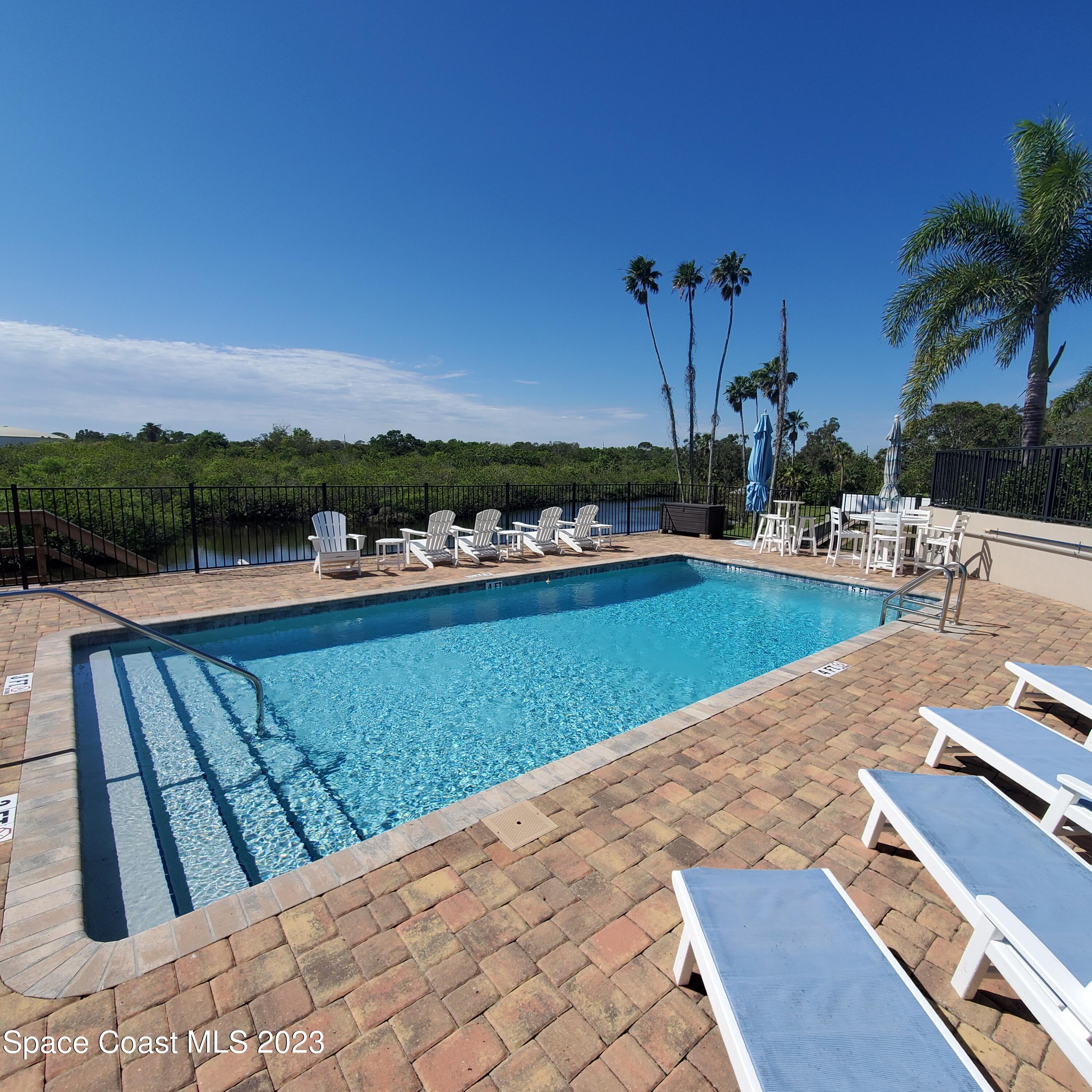 2240 Enjoya Lane Melbourne, FL 32901 - Photo 25 of 31 a view of a lake with houses in the back