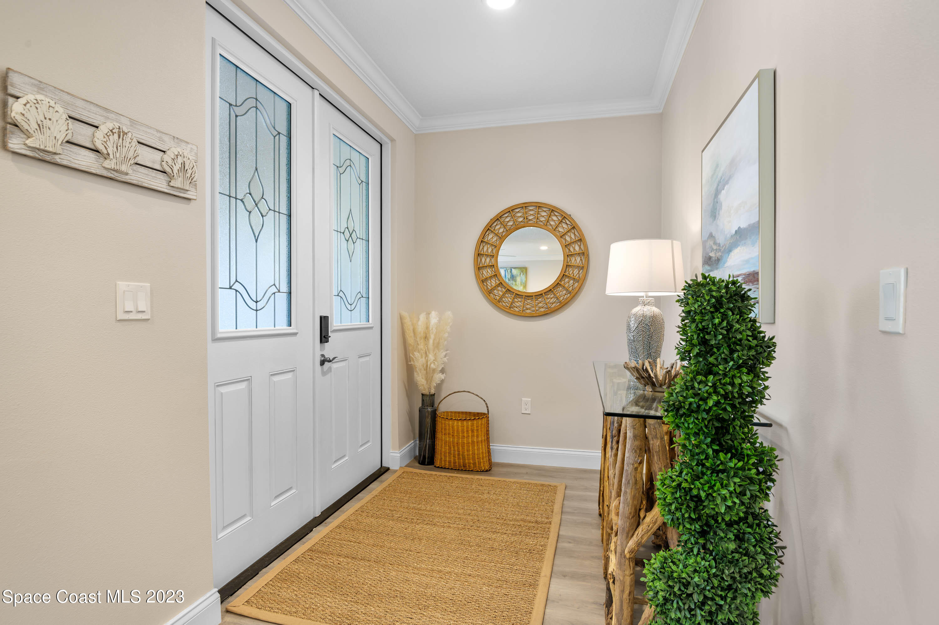 2240 Enjoya Lane Melbourne, FL 32901 - Photo 3 of 31 a very nice looking room with a large mirror and a white walls