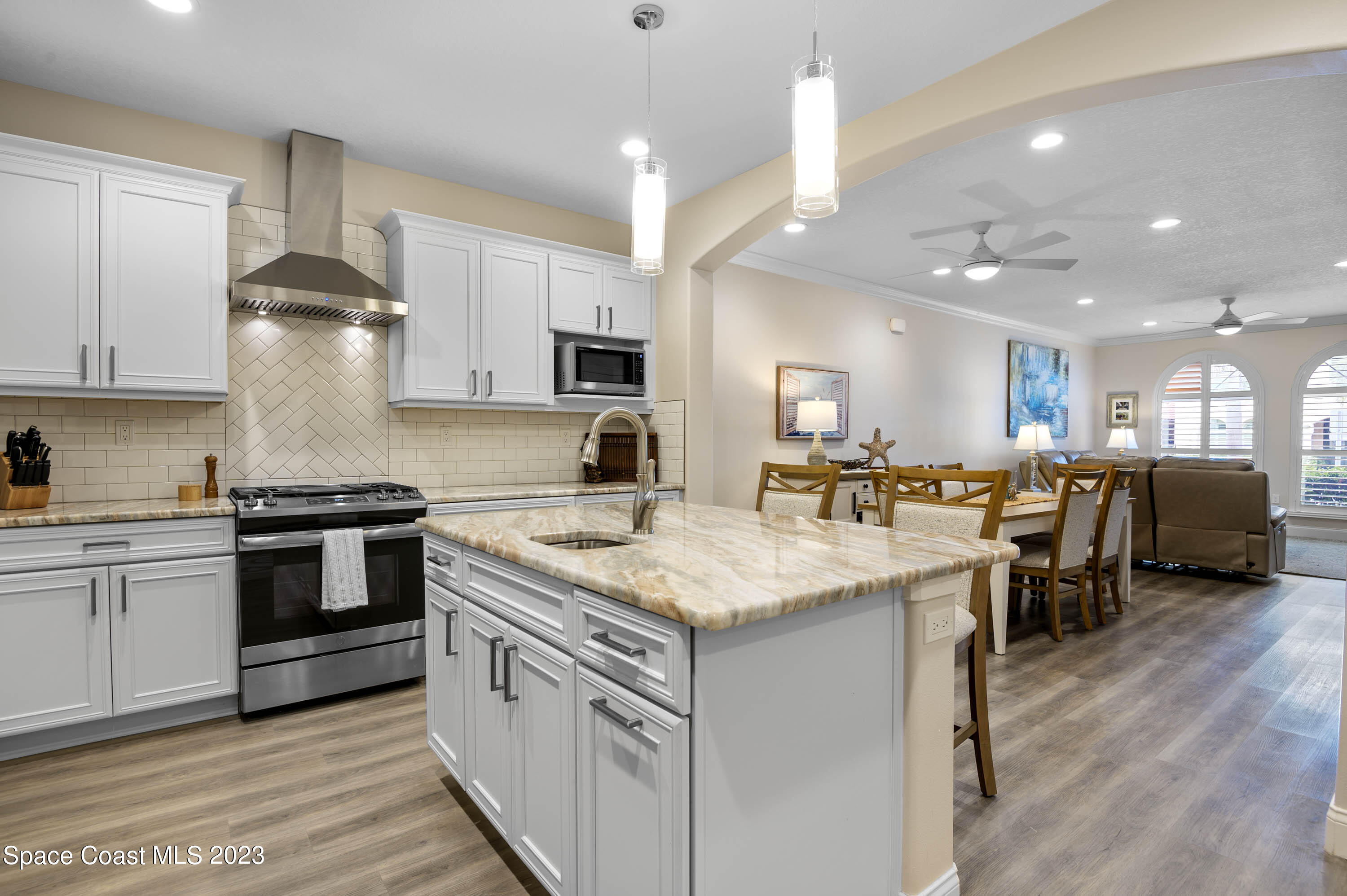 2240 Enjoya Lane Melbourne, FL 32901 - Photo 8 of 31 a kitchen with kitchen island granite countertop lots of counter top space and stainless steel appliances