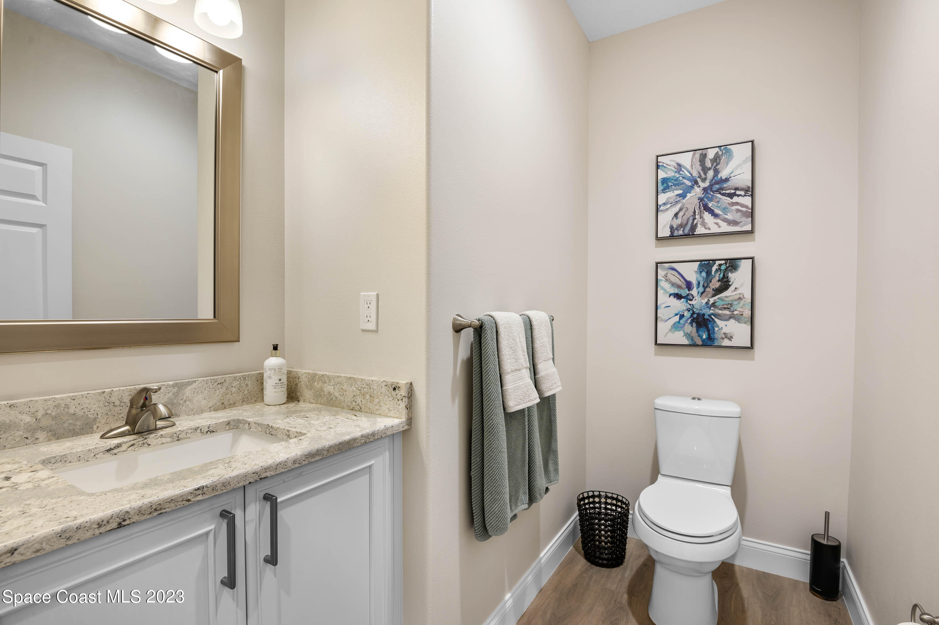 2240 Enjoya Lane Melbourne, FL 32901 - Photo 10 of 31 a bathroom with a granite countertop toilet sink and a mirror