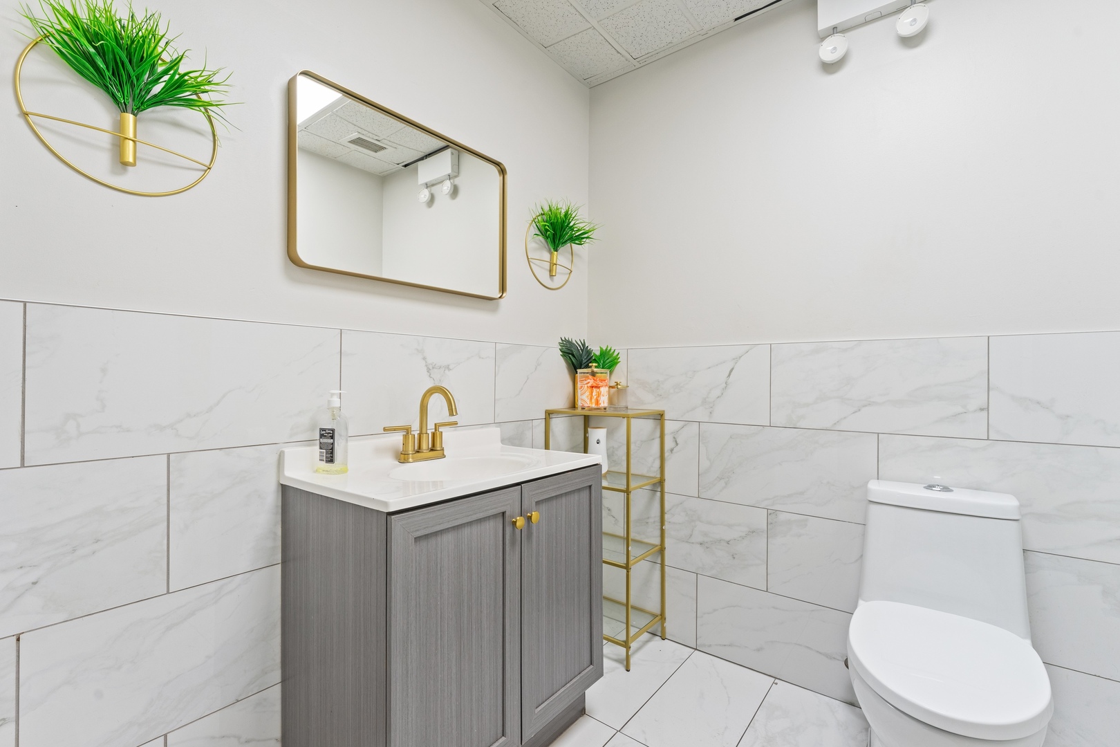 5744 West Irving Park Road Chicago, IL 60634 - Photo 12 of 17 a bathroom with a sink a toilet and a mirror