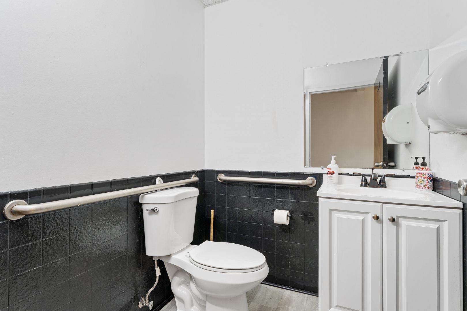 5744 West Irving Park Road Chicago, IL 60634 - Photo 13 of 17 a bathroom with a toilet sink and mirror