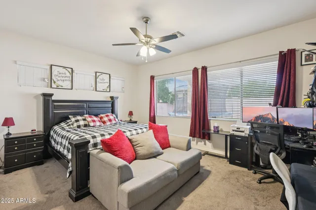 a living room with furniture fireplace and a large window