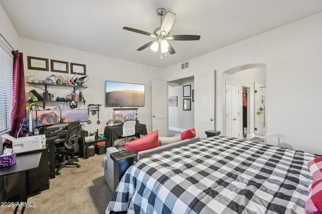 a bedroom with a bed and a flat tv screen