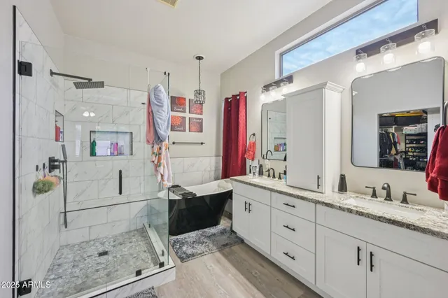 a bathroom with a granite countertop sink mirror and shower
