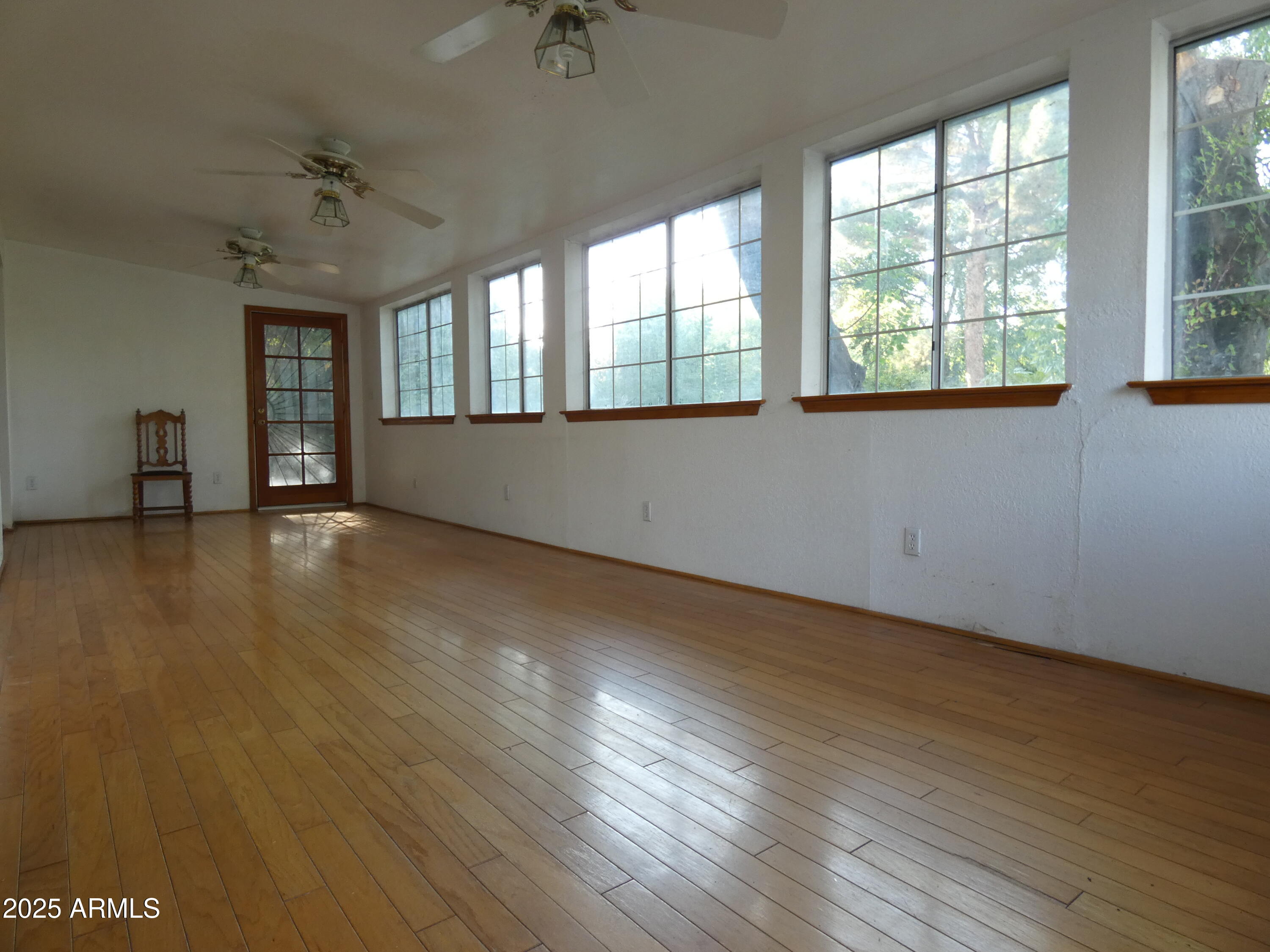 3214 West State Avenue Phoenix, AZ 85051 - Photo 11 of 35 an empty room with wooden floor and windows