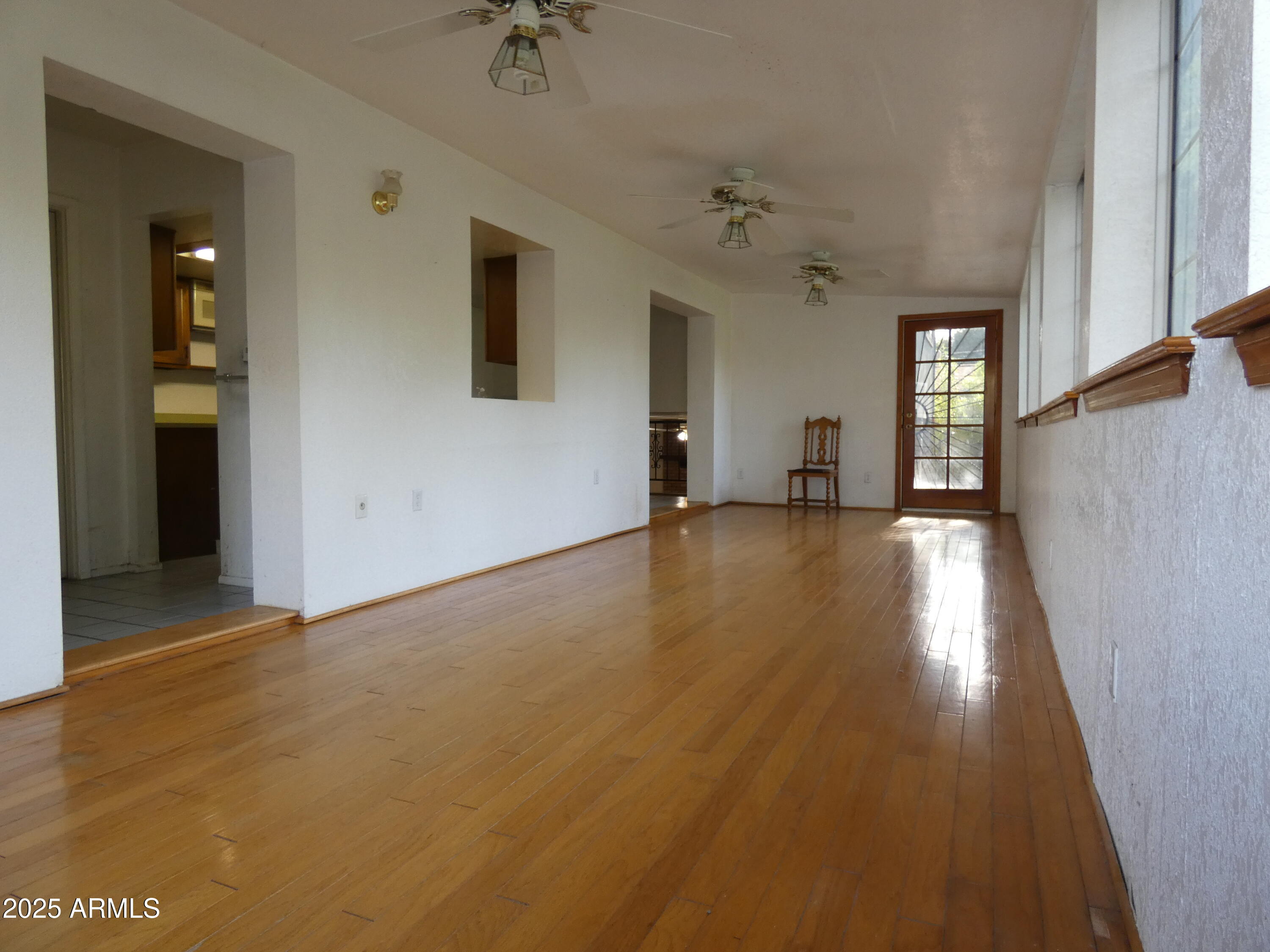 3214 West State Avenue Phoenix, AZ 85051 - Photo 12 of 35 wooden floor in an empty room with a window