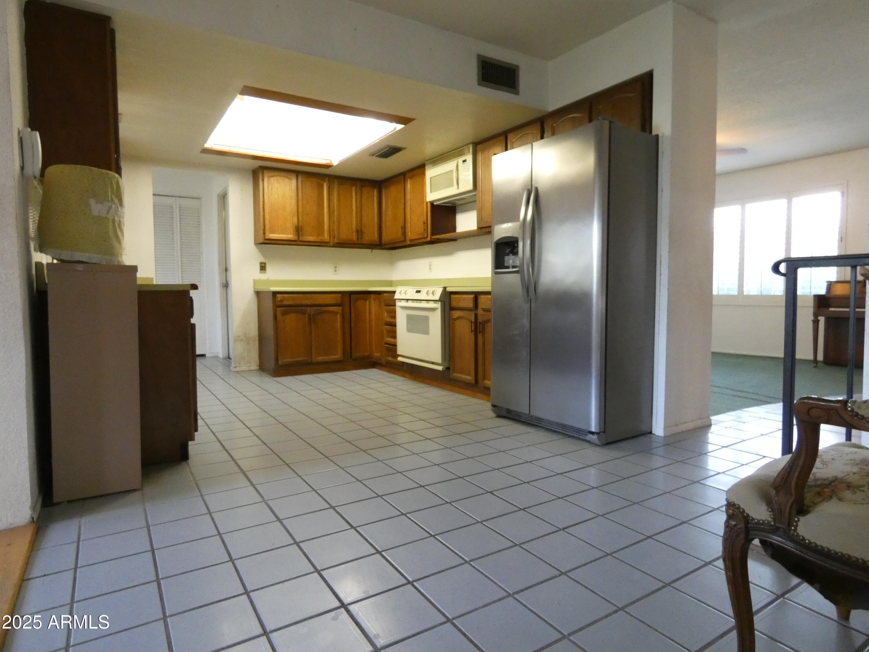 3214 West State Avenue Phoenix, AZ 85051 - Photo 13 of 35 a kitchen with granite countertop a refrigerator and a stove top oven