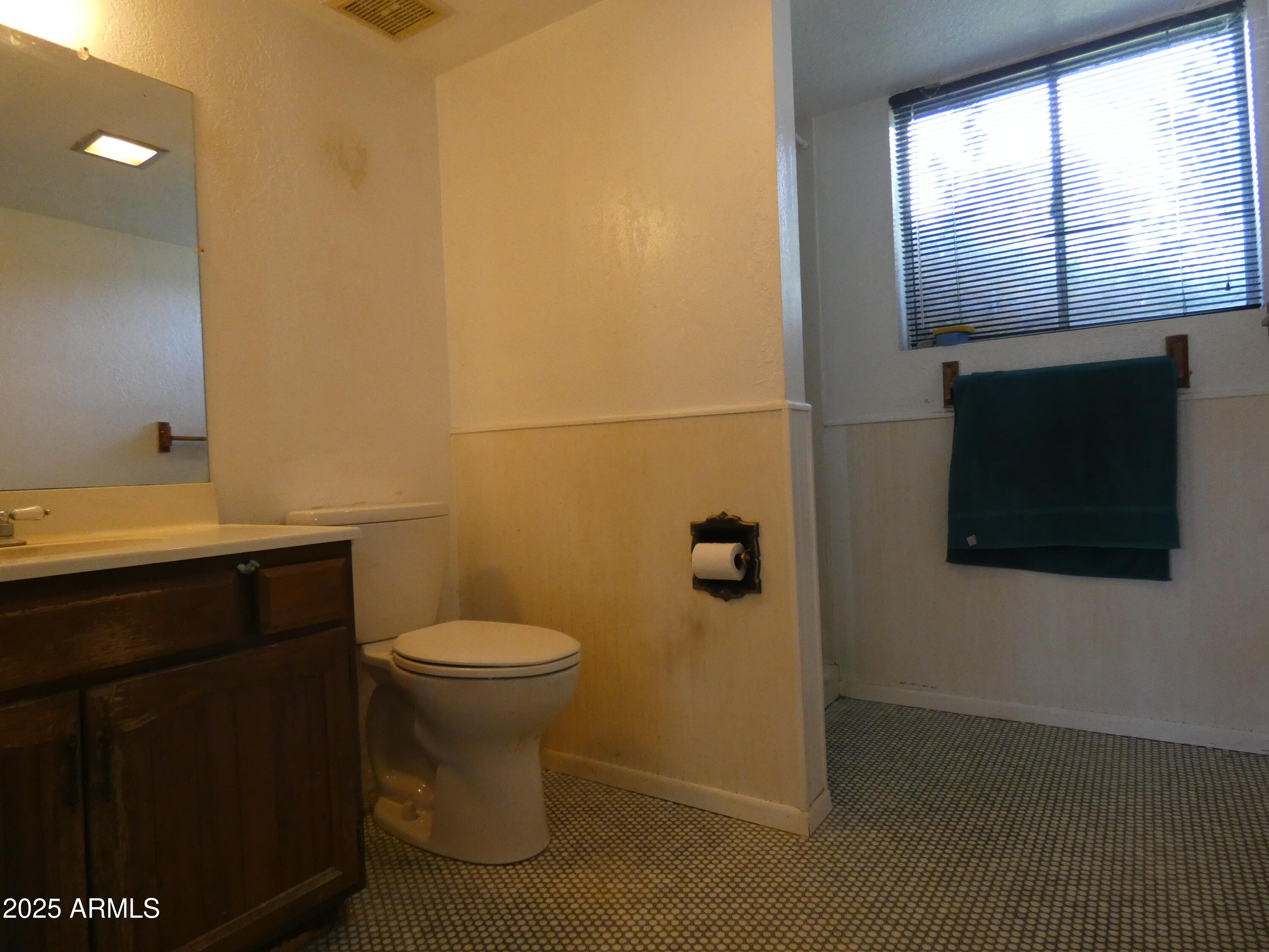 3214 West State Avenue Phoenix, AZ 85051 - Photo 19 of 35 a bathroom with a toilet a sink and window