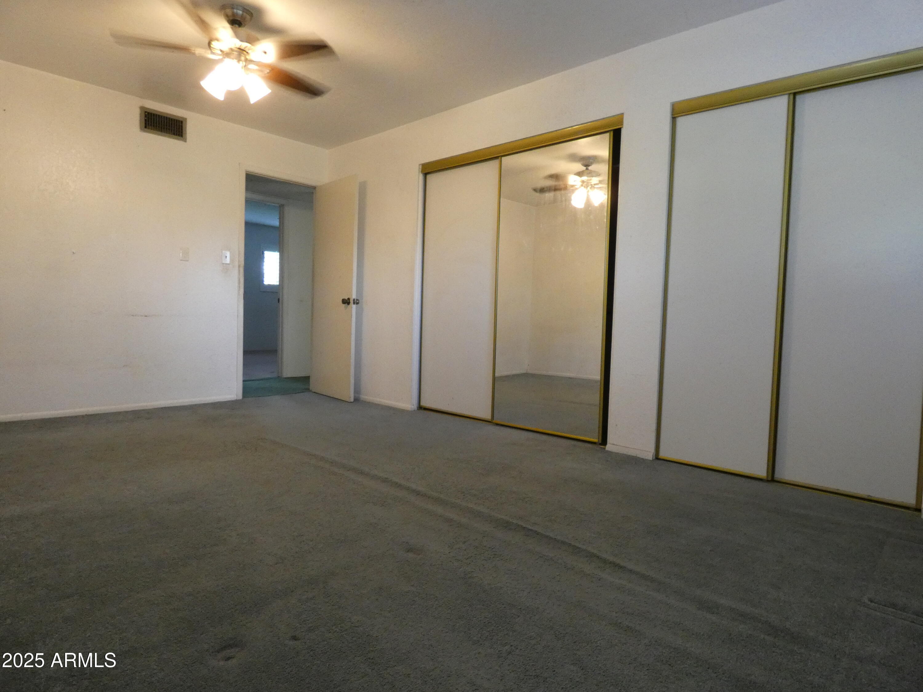 3214 West State Avenue Phoenix, AZ 85051 - Photo 22 of 35 a view of a hallway with a chandelier fan and a table