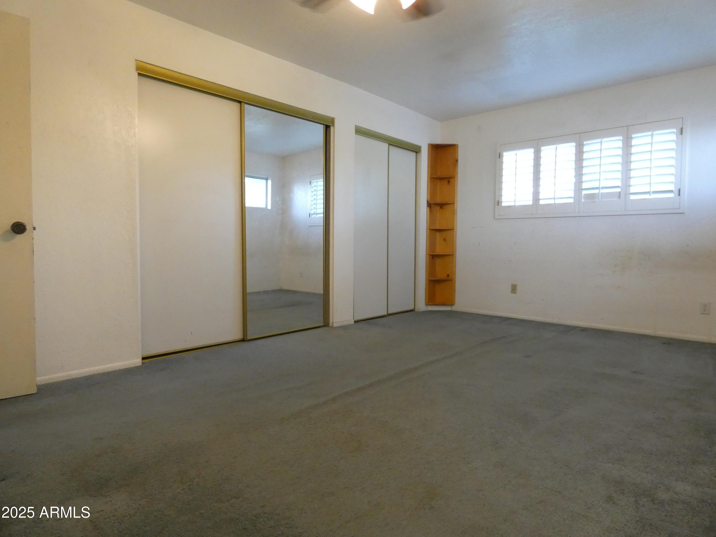 3214 West State Avenue Phoenix, AZ 85051 - Photo 23 of 35 an empty room with windows and closet