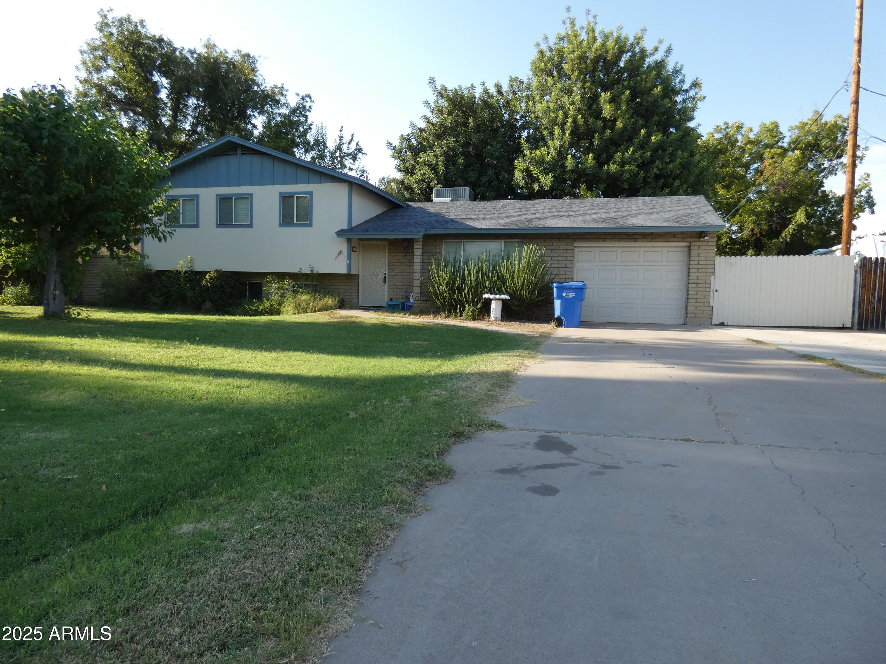 3214 West State Avenue Phoenix, AZ 85051 - Photo 6 of 35 a front view of a house with a yard and garage