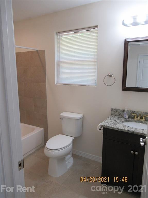 858 Horseshoe Lake Road Lincolnton, NC 28092 - Photo 12 of 16 a bathroom with a granite countertop toilet a sink and a mirror