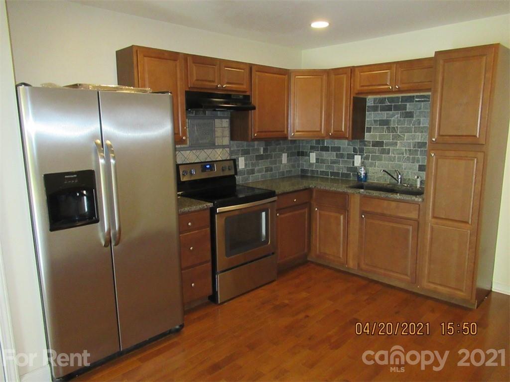 858 Horseshoe Lake Road Lincolnton, NC 28092 - Photo 7 of 16 a kitchen with stainless steel appliances granite countertop a refrigerator and a sink