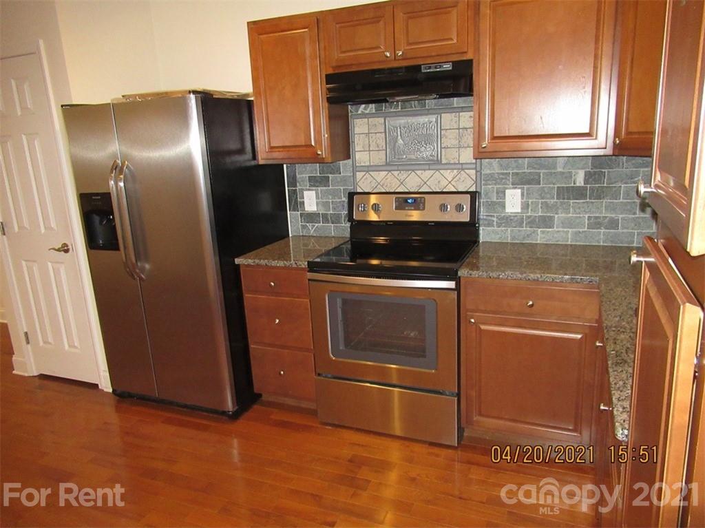 858 Horseshoe Lake Road Lincolnton, NC 28092 - Photo 8 of 16 a kitchen with granite countertop stainless steel appliances and wooden cabinets