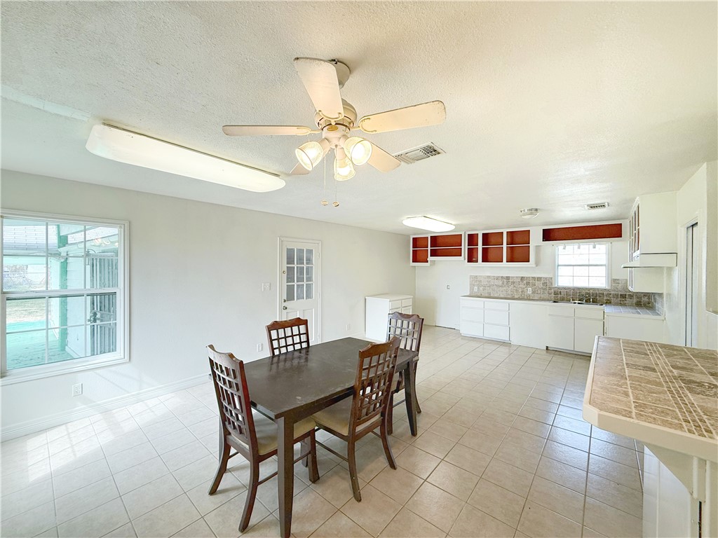 2325 1st Street Ingleside, TX 78362 - Photo 17 of 31 a view of a dining room with furniture and a kitchen