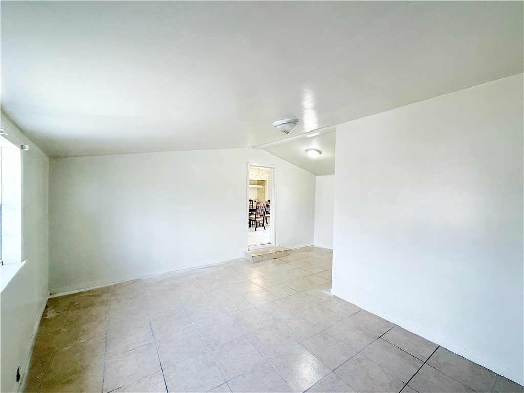 2325 1st Street Ingleside, TX 78362 - Photo 21 of 31 an empty room with a chandelier fan and windows