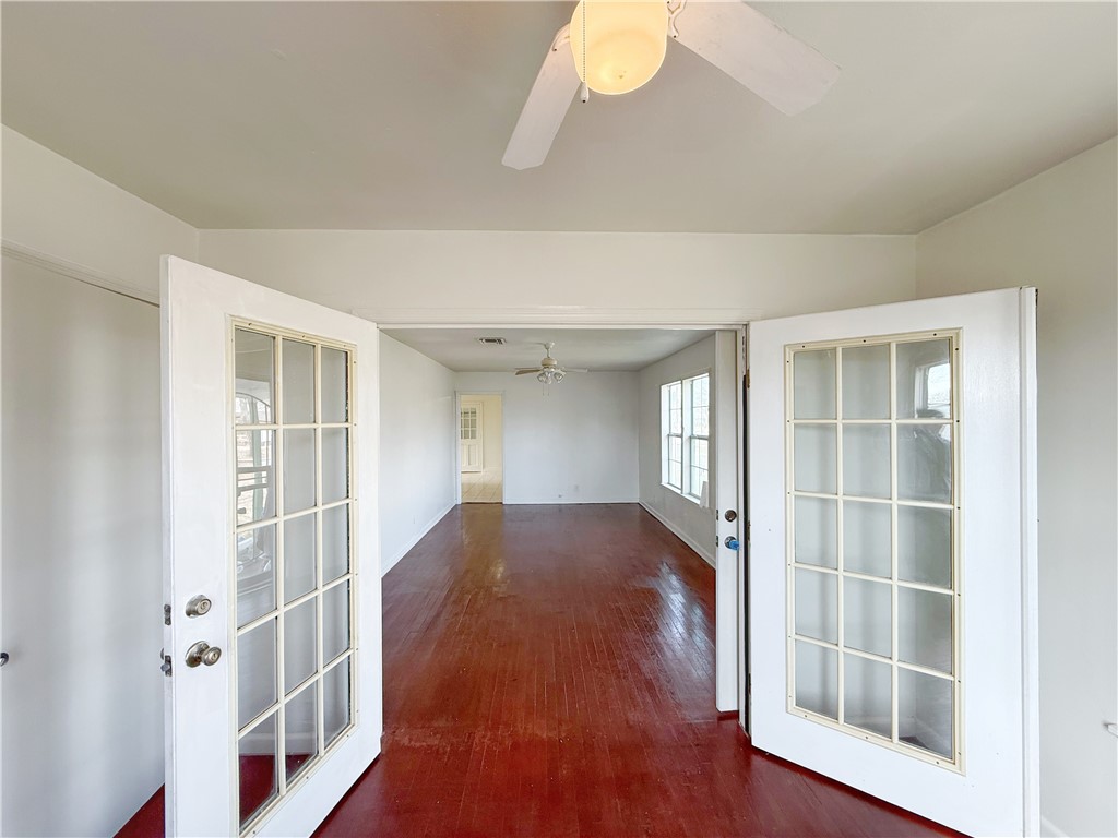 2325 1st Street Ingleside, TX 78362 - Photo 3 of 31 a view of an empty room with wooden floor and a window