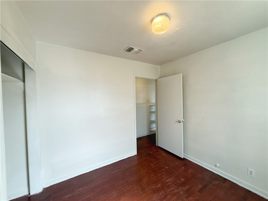 2325 1st Street Ingleside, TX 78362 - Photo 8 of 31 an empty room with wooden floor and windows