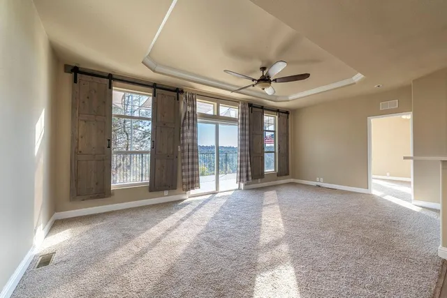 a view of a livingroom with a ceiling fan and window