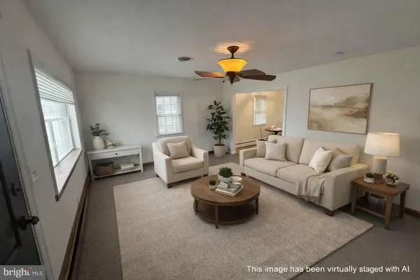 a living room with furniture and a painting on the wall