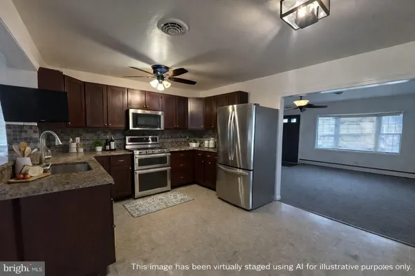a kitchen with granite countertop stainless steel appliances cabinets a sink and a window
