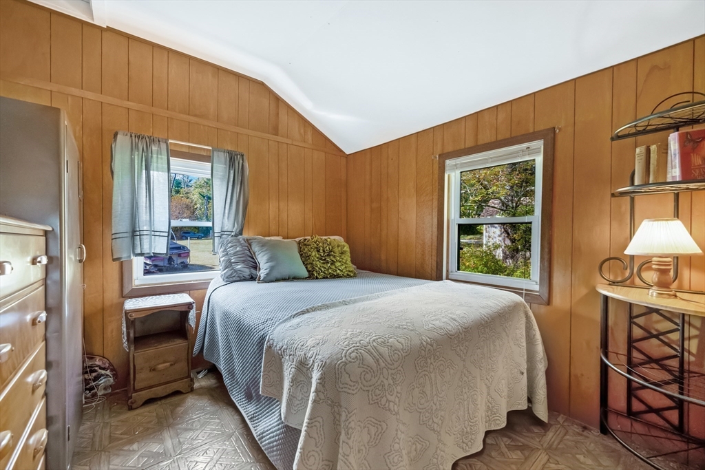 79 7th Street Brimfield, MA 01010 - Photo 19 of 32 a bedroom with a bed a mirror on dresser and a window