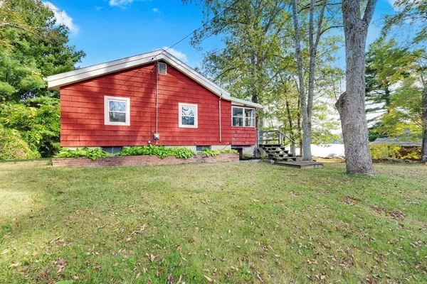 a view of a house with a yard and tree s